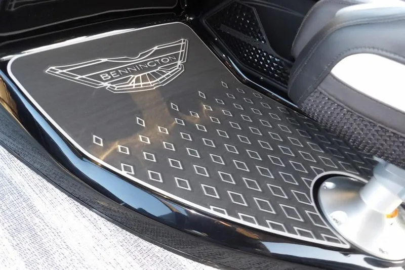 Slide: The Image of 2026 Bennington M Swingback 26 MSB boat floor with logo and diamond pattern design. - 26