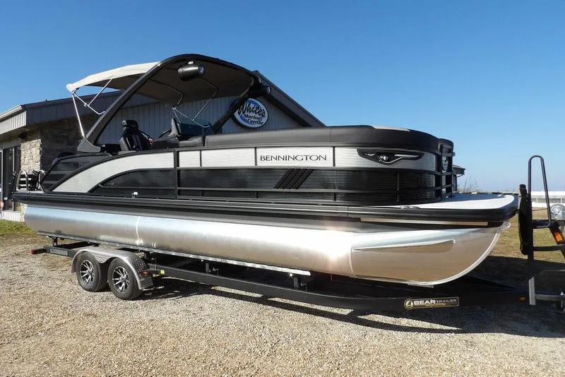 Slide: The Image of 2026 Bennington M Swingback 26 MSB pontoon boat on trailer, outdoor setting. - 3