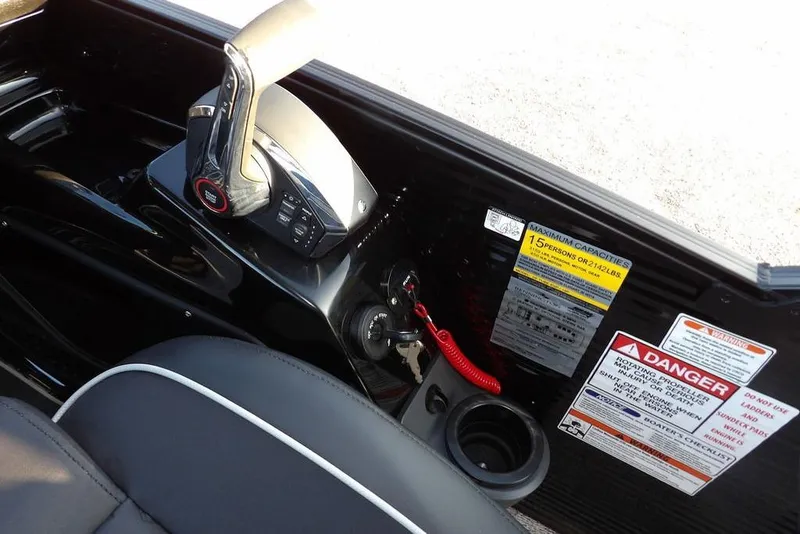 Slide: The Image of Control panel of 2026 Bennington M Swingback 26 MSB with safety warnings and throttle lever. - 34