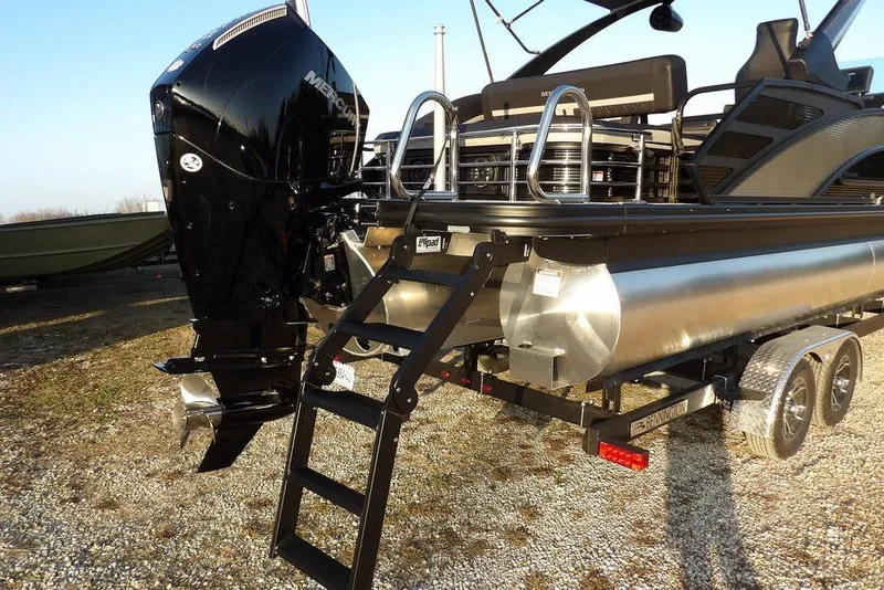 Slide: The Image of 2026 Bennington M Swingback 26 MSB pontoon boat with Mercury outboard engine and trailer. - 49