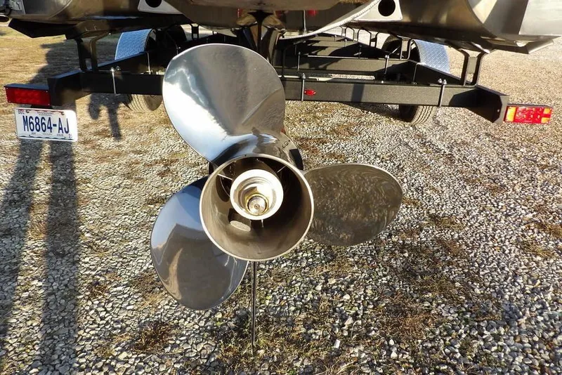 Slide: The Image of 2026 Bennington M Swingback 26 MSB boat propeller on a trailer, gravel background. - 53