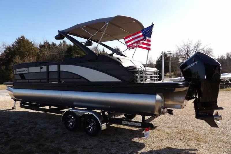 Slide: The Image of 2026 Bennington M Swingback 26 MSB pontoon boat with Mercury engine and American flag. - 6