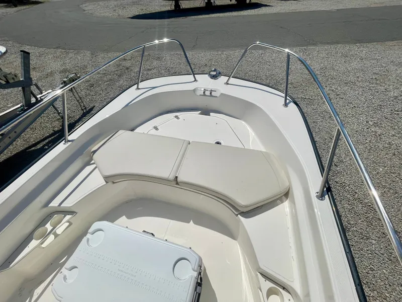 Slide: The Image of The image shows the bow of a Boston Whaler 170 Montauk with seating cushions and stainless steel railing. - 12