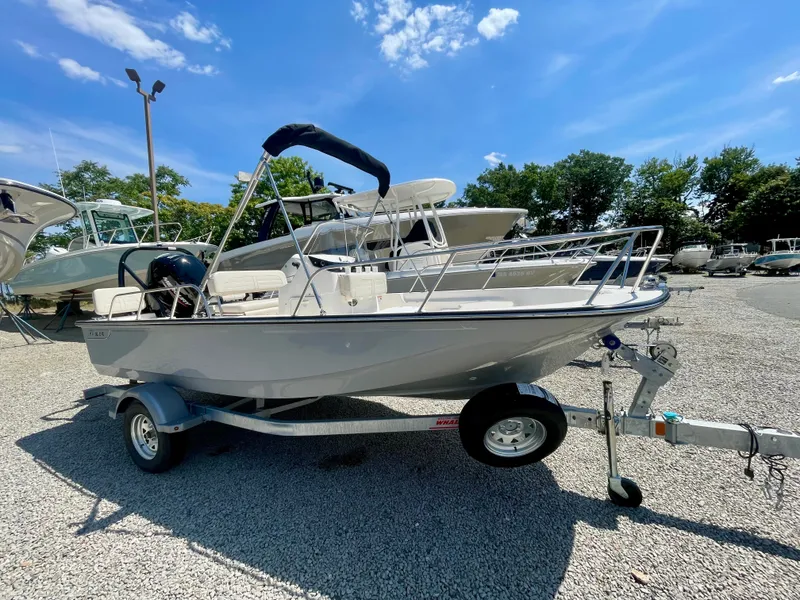 Slide: The Image of Boston Whaler 170 Montauk 2026 on a trailer outdoors, surrounded by other boats. - 1