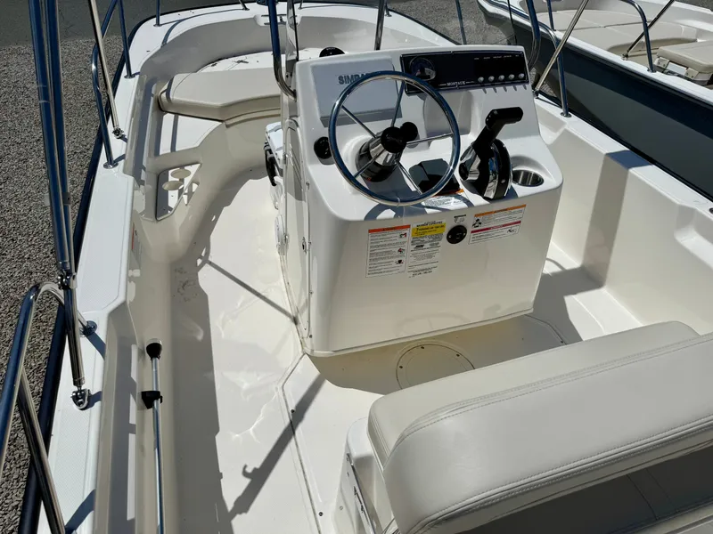 Slide: The Image of The image shows the cockpit of a 2026 Boston Whaler 170 Montauk with a helm console and seating. - 11