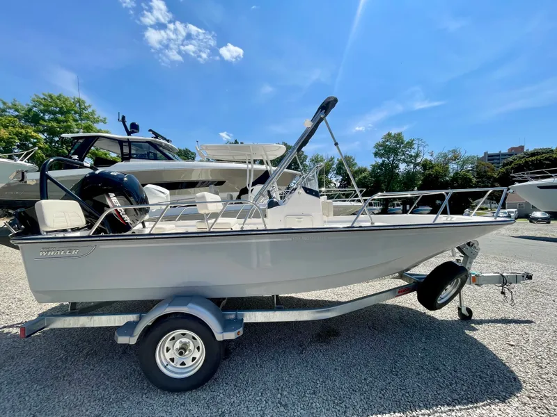 Slide: The Image of A 2026 Boston Whaler 170 Montauk on a trailer under a blue sky. - 0