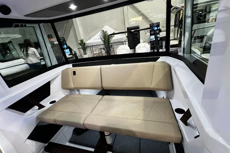 Slide: The Image of 2026 Axopar 29 XC Cross Cabin interior with beige seating and modern design. - 11