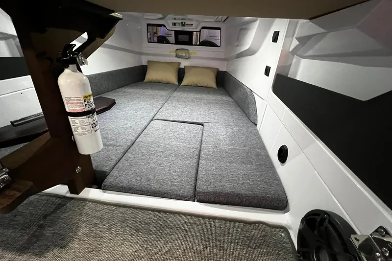 Slide: The Image of 2026 Axopar 29 XC Cross Cabin interior with cozy sleeping area and fire extinguisher. - 12