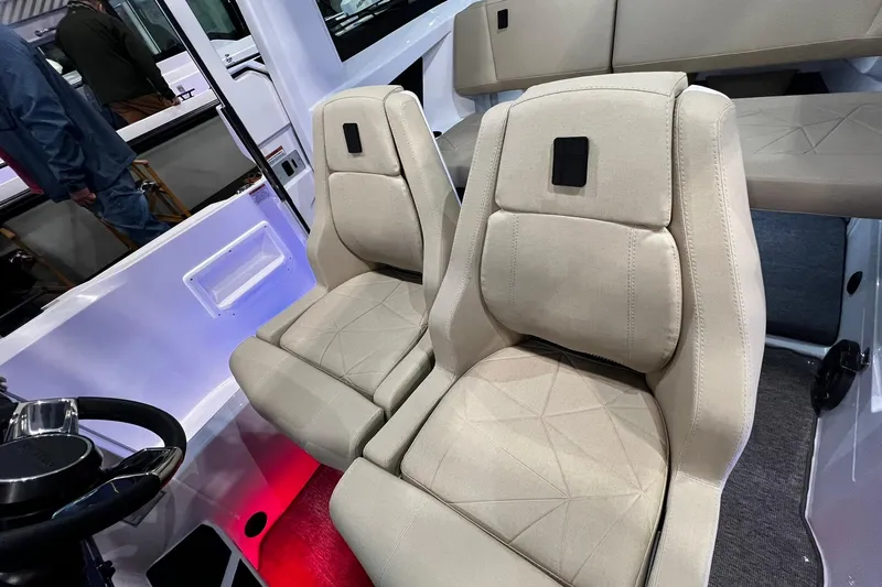Slide: The Image of 2026 Axopar 29 XC Cross Cabin interior with beige seats and modern design. - 13