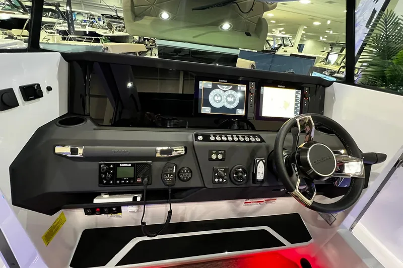 Slide: The Image of 2026 Axopar 29 XC Cross Cabin dashboard with advanced navigation and control systems. - 16