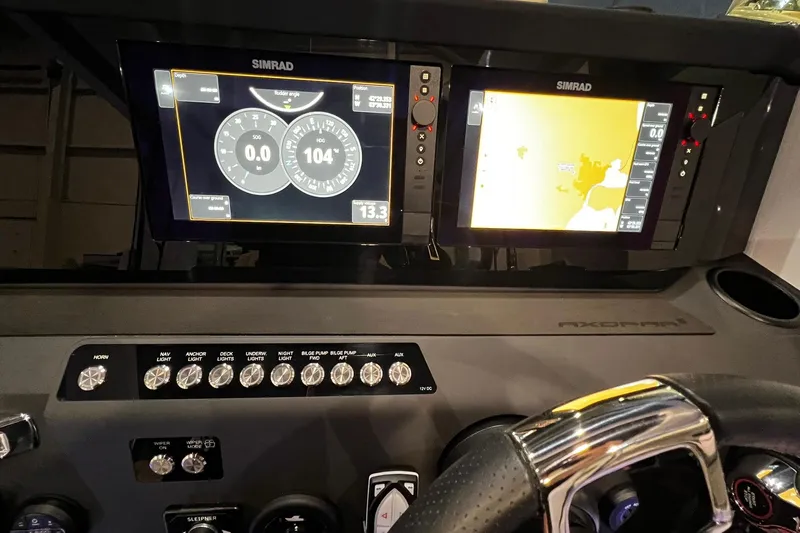 Slide: The Image of Dashboard of 2026 Axopar 29 XC Cross Cabin with Simrad navigation displays. - 18