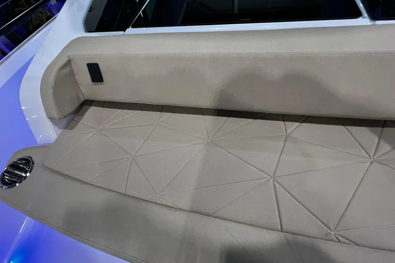 Slide: The Image of 2026 Axopar 29 XC Cross Cabin interior with beige geometric-patterned seating. - 21
