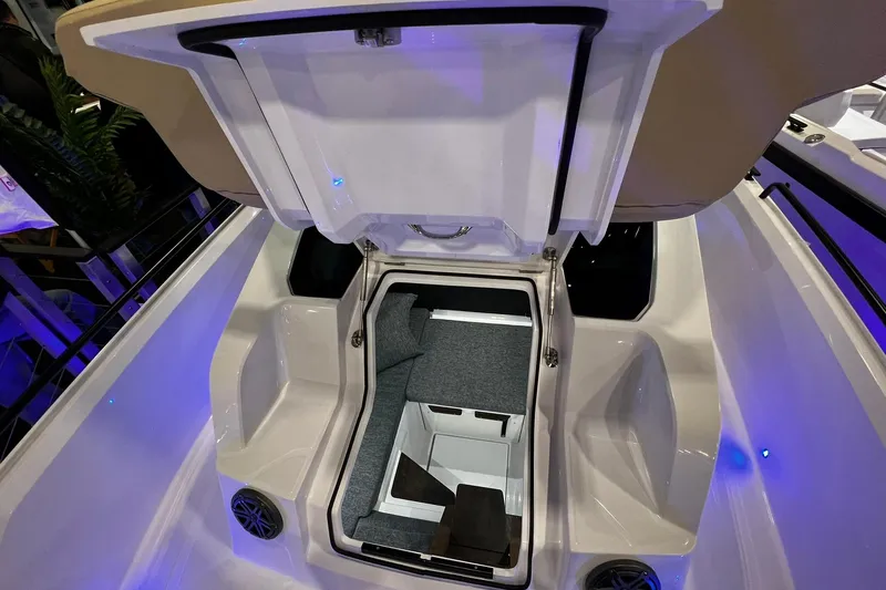 Slide: The Image of 2026 Axopar 29 XC Cross Cabin interior storage compartment with open hatch, showcasing modern design. - 22