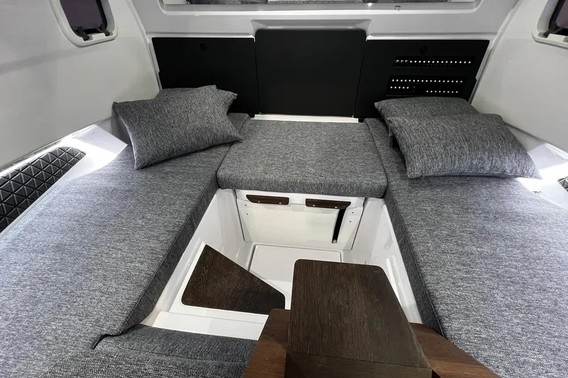 Slide: The Image of 2026 Axopar 29 XC Cross Cabin interior with gray cushions and modern design. - 23