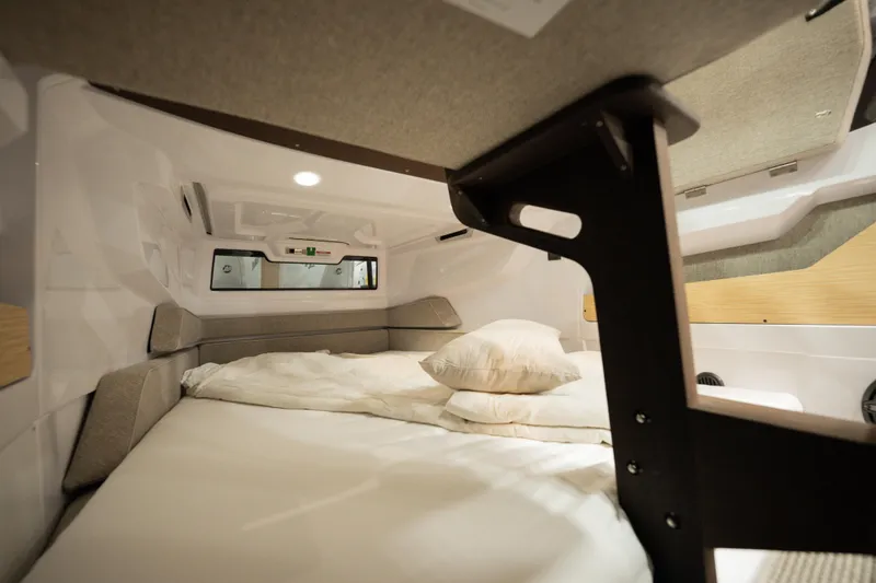 Slide: The Image of Cozy cabin interior of 2026 Axopar 29 XC Cross Cabin with bed and pillows. - 7