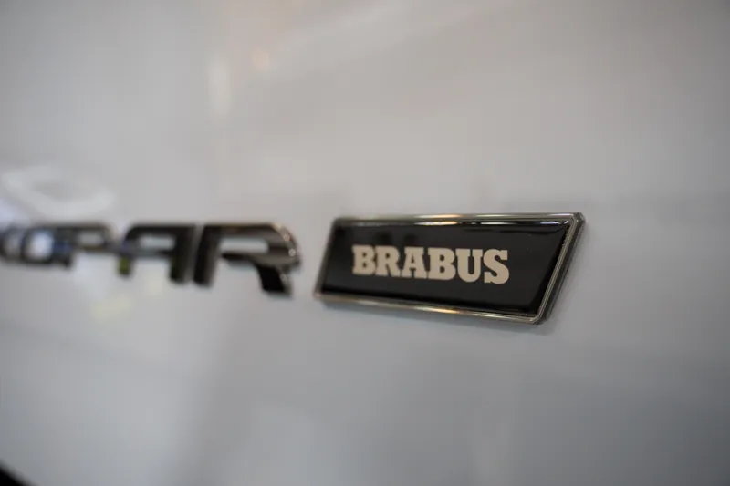 Slide: The Image of Close-up of 2026 Axopar 29 XC Cross Cabin Brabus badge on white surface. - 8