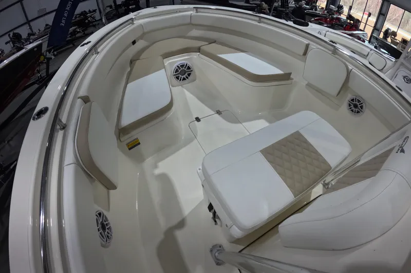 Slide: The Image of 2026 Bulls Bay 255 Center Console boat interior with cushioned seating and speakers. - 14