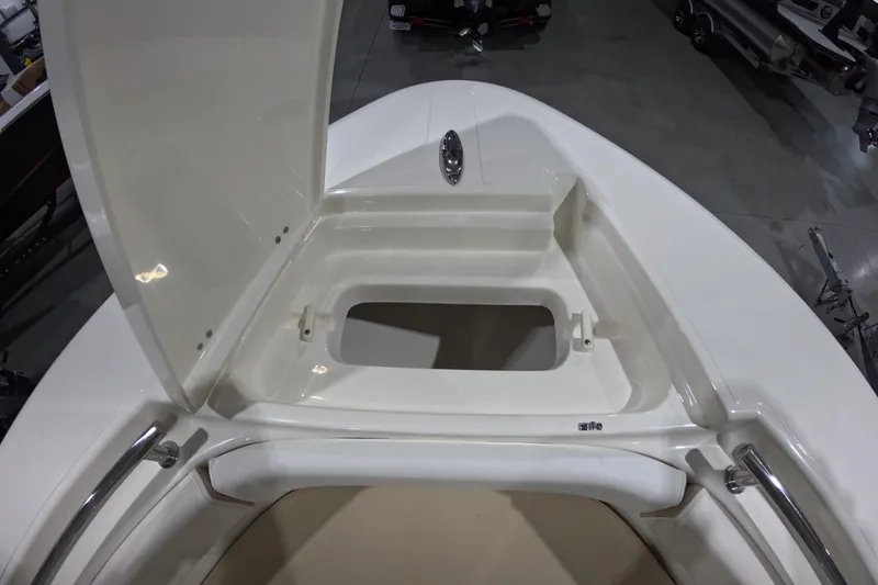 Slide: The Image of 2026 Bulls Bay 255 Center Console boat storage compartment open, showcasing interior space. - 18