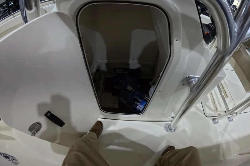 Slide: The Image of 2026 Bulls Bay 255 Center Console boat storage compartment with open door. - 21