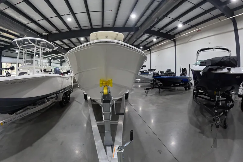 Slide: The Image of 2026 Bulls Bay 255 Center Console boat displayed in a showroom with other boats. - 3