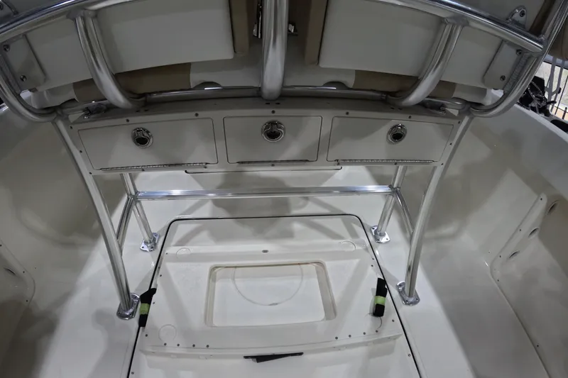 Slide: The Image of 2026 Bulls Bay 255 Center Console boat interior with storage compartments and stainless steel frame. - 9