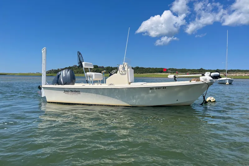 The Image of 2008 Jones Brothers 18 Cape Fisherman boat on calm water under blue sky. - 0