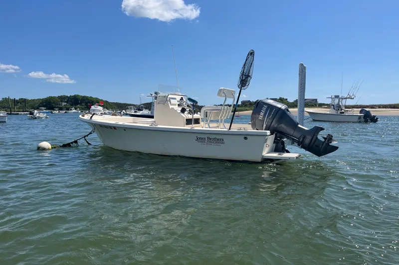 Slide: The Image of Jones Brothers 18 Cape Fisherman boat, 2008 model, anchored in a sunny harbor. - 1