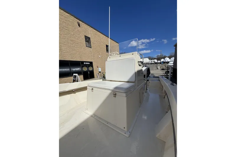 Slide: The Image of 2008 Jones Brothers Cape Fisherman 18 boat, beige interior, outdoor setting, clear blue sky. - 6