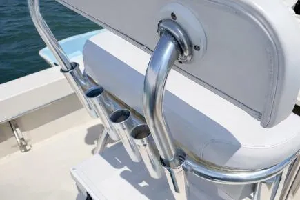 Slide: The Image of 2008 Jones Brothers 18 Cape Fisherman boat with rod holders and cushioned seating. - 9