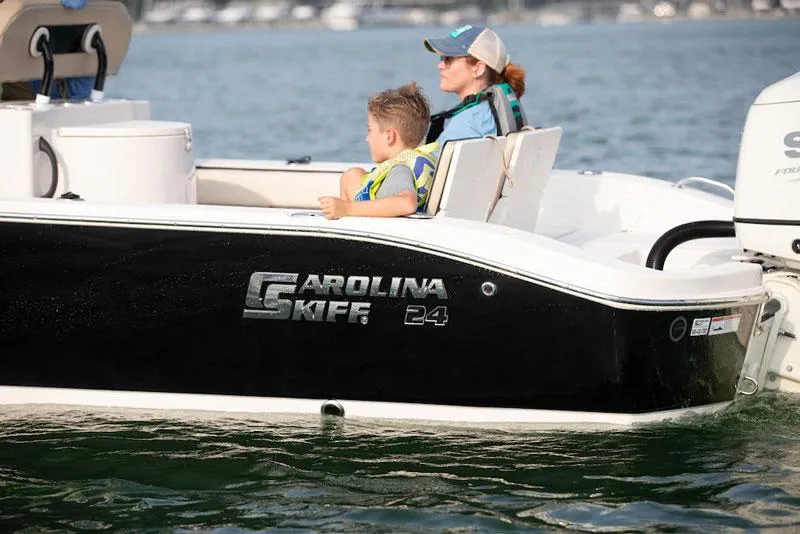 Slide: The Image of Manufacturer Provided Image: 2026 Carolina Skiff 24 Ultra Elite boat cruising on a lake with passengers. - 6