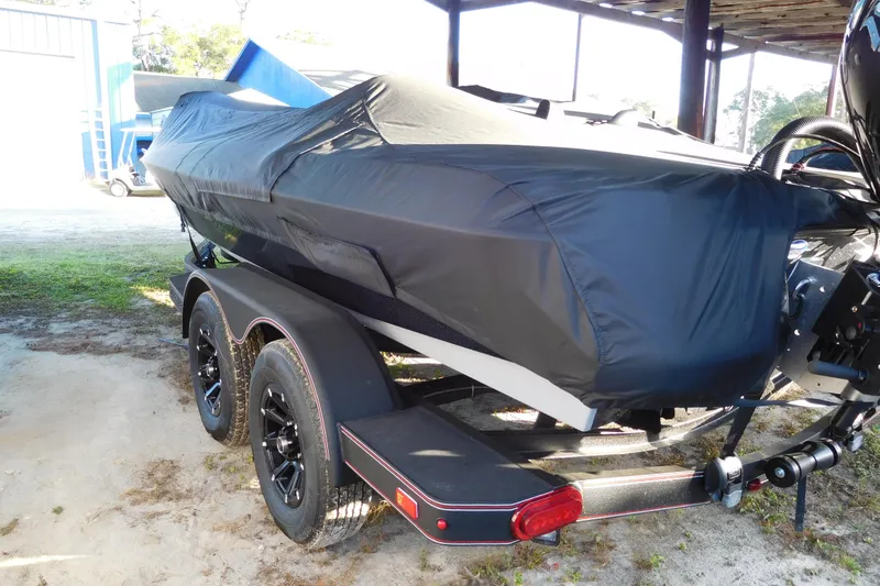 The Image of Covered 2026 Skeeter ZXE20 boat on trailer, parked outdoors. - 1