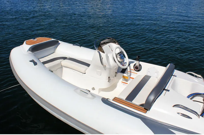 Slide: The Image of Manufacturer Provided Image: 2025 Walker Bay Generation 360 DLX boat on calm water, featuring sleek design and comfortable seating. - 5