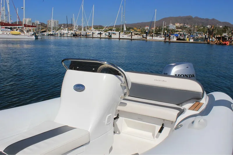 Slide: The Image of Manufacturer Provided Image: 2025 Walker Bay Generation 360 DLX boat docked in marina with scenic background. - 9