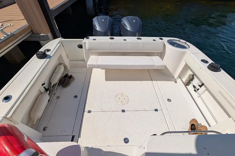 Slide: The Image of 2014 Robalo R305 Walkaround boat deck with seating and storage compartments. - 12