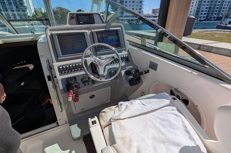 Slide: The Image of 2014 Robalo R305 Walkaround helm with dual screens and steering wheel. - 19