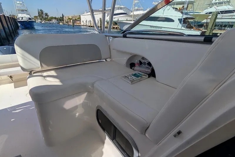 Slide: The Image of 2014 Robalo R305 Walkaround boat interior with white seating and waterfront view. - 23