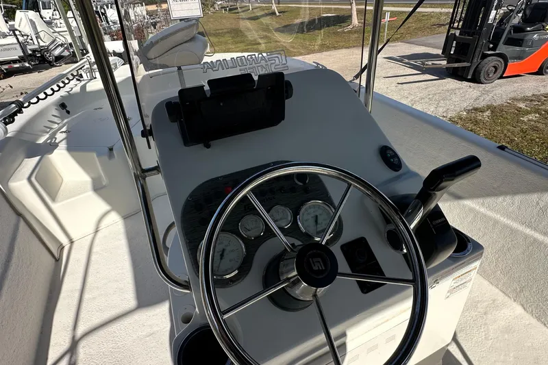Slide: The Image of 2017 Carolina Skiff 198 DLV boat console with steering wheel and controls. - 11