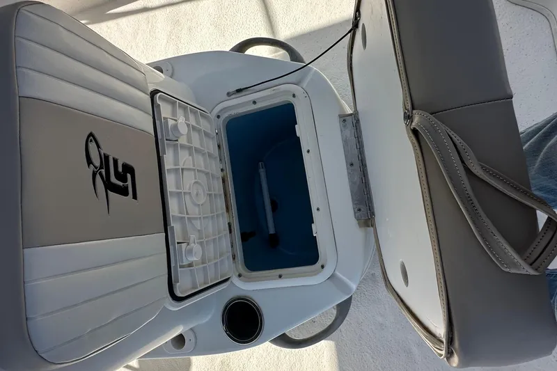 Slide: The Image of 2017 Carolina Skiff 198 DLV boat seat with storage compartment open. - 14