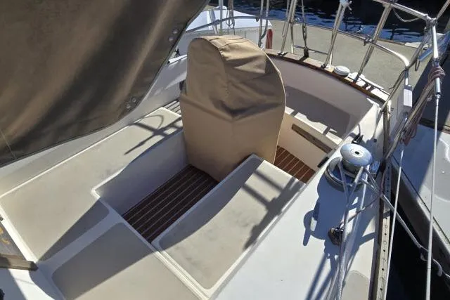 Slide: The Image of 1980 CAL 39 sailboat cockpit with covered helm and wooden flooring. - 11