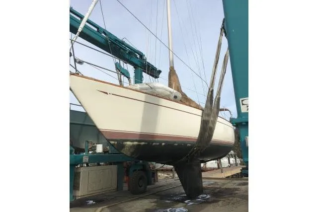 Slide: The Image of 1980 CAL 39 sailboat in dry dock, undergoing maintenance and inspection. - 16