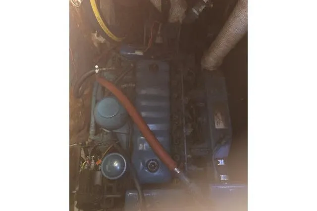 Slide: The Image of 1980 CAL 39 engine compartment with blue engine and red hose. - 17