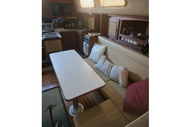 Slide: The Image of Interior of 1980 CAL 39 sailboat with dining area and cushions. - 3