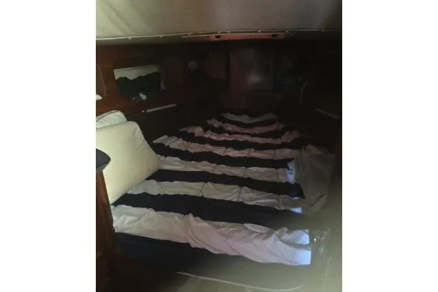 Slide: The Image of Cozy cabin interior of 1980 CAL 39 sailboat with striped bedding. - 7