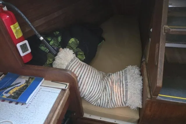 Slide: The Image of Cozy cabin interior of 1980 CAL 39 sailboat with striped pillow and fire extinguisher. - 9