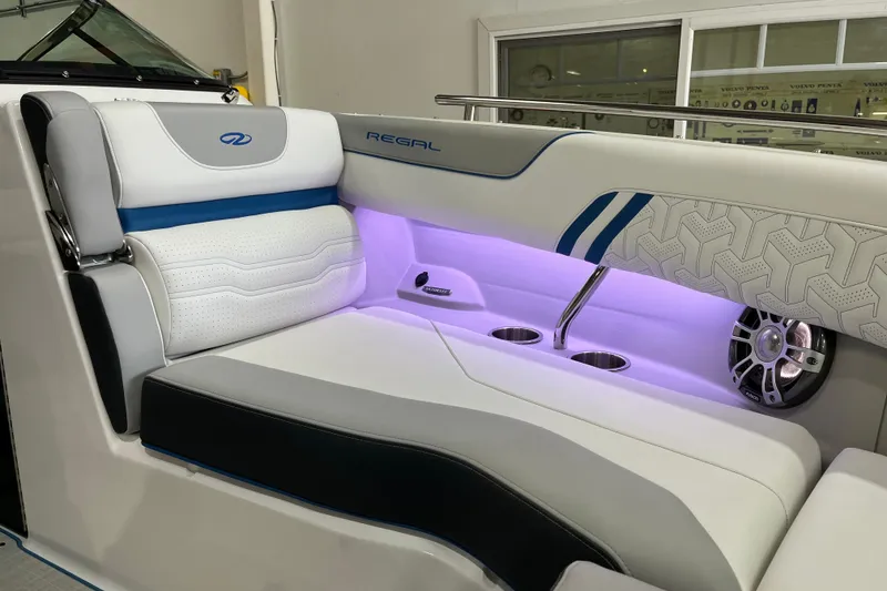 Slide: The Image of 2024 Regal LS4 Surf boat interior with illuminated seating and cup holders. - 15
