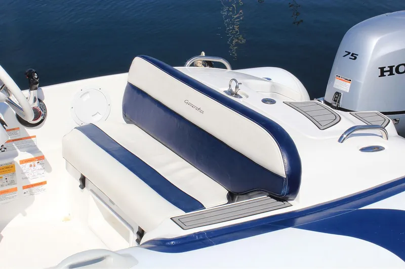 Slide: The Image of Manufacturer Provided Image: Walker Bay Generation 450 DLX 2025 boat interior with blue and white seating, Honda motor. - 7