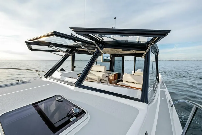 Slide: The Image of 2025 MJM 42 yacht with open sunroof, cruising on calm waters. - 25