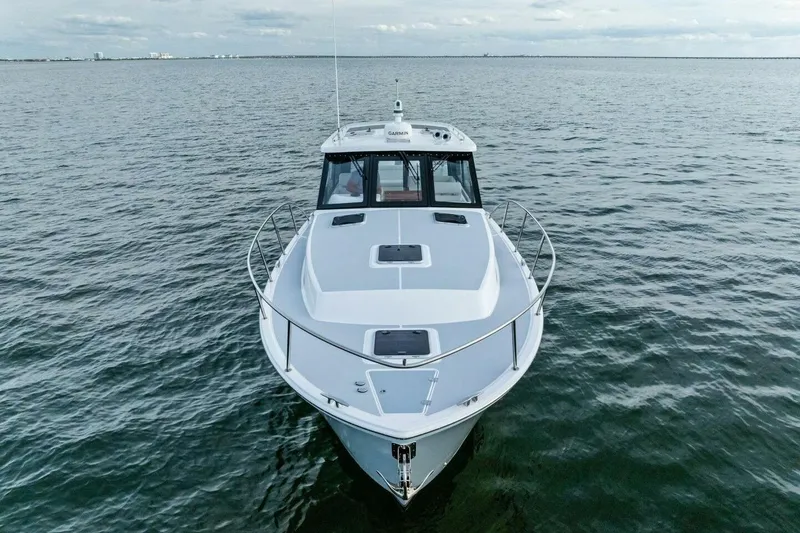 Slide: The Image of 2025 MJM 42 boat cruising on open water, showcasing sleek design and modern features. - 34