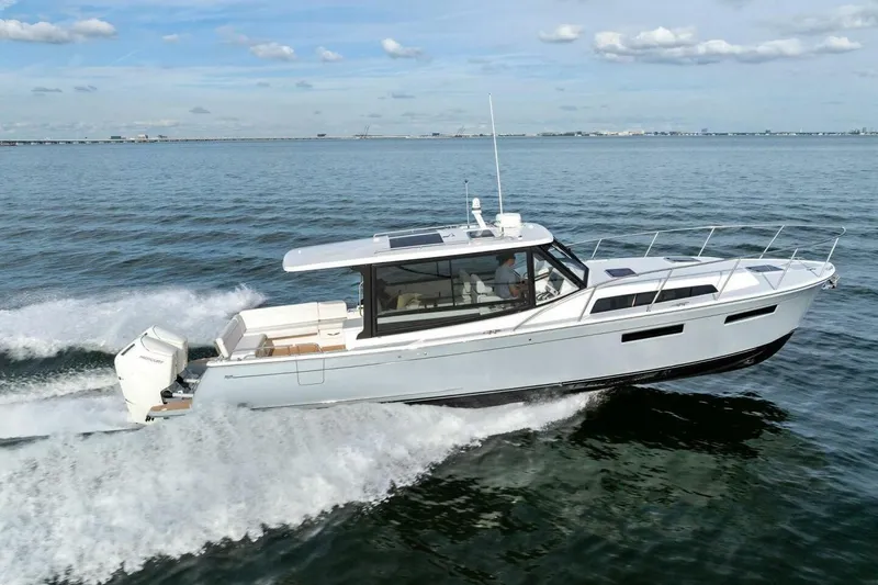 Slide: The Image of 2025 MJM 42 boat cruising on open water under a clear sky. - 40