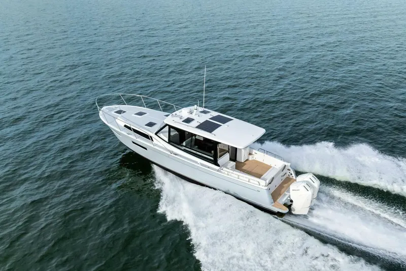 Slide: The Image of 2025 MJM 42 yacht cruising on open water, showcasing sleek design and powerful engines. - 44